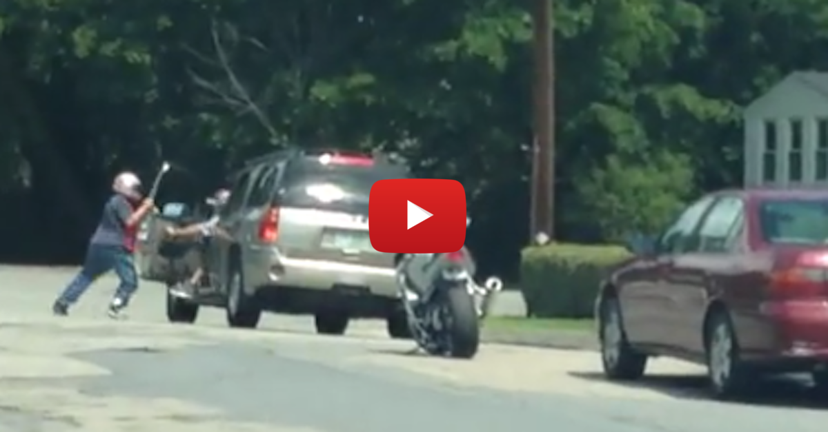 Road rage motorcyclist gets hit with a baseball bat after swinging at SUV driver