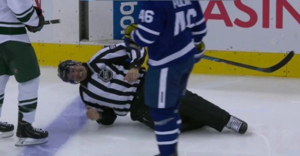 This NHL linesman got hit in the knee with a puck and it looked like he would pass out from pain
