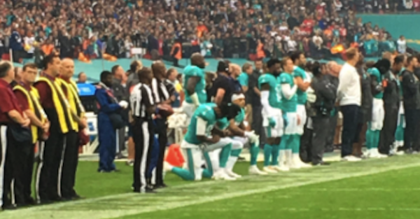 Three Dolphins players kneel in London for the national anthem