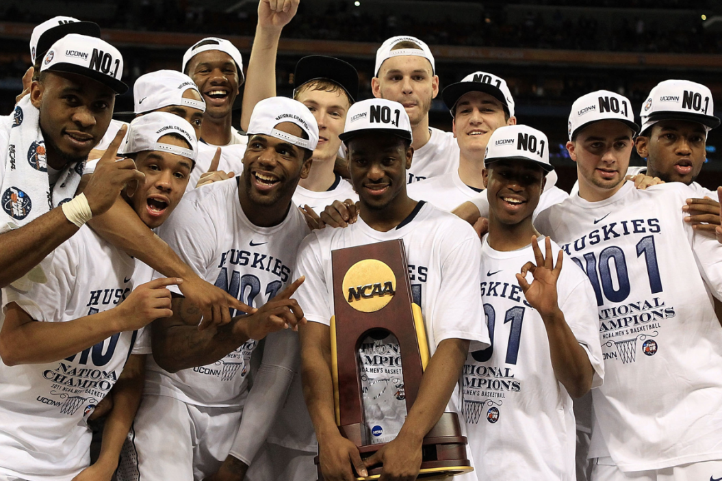 Kemba Walker #15 of the Connecticut Huskies holds the trophy as he and his team celebrate after defeating the Butler Bulldogs to win the National Championship Game of the 2011 NCAA Division I Men's Basketball Tournament