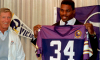 Herschel Walker holds up a Vikings jersey after being traded to Minnesota.