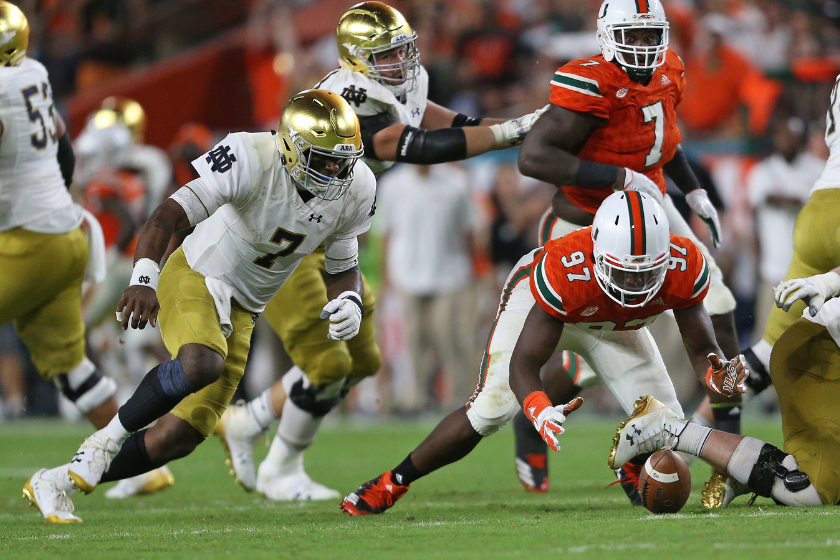 Jonathan Garvin #97 of the Miami Hurricanes recovers the fumble by Brandon Wimbush #7 of the Notre Dame Fighting Irish