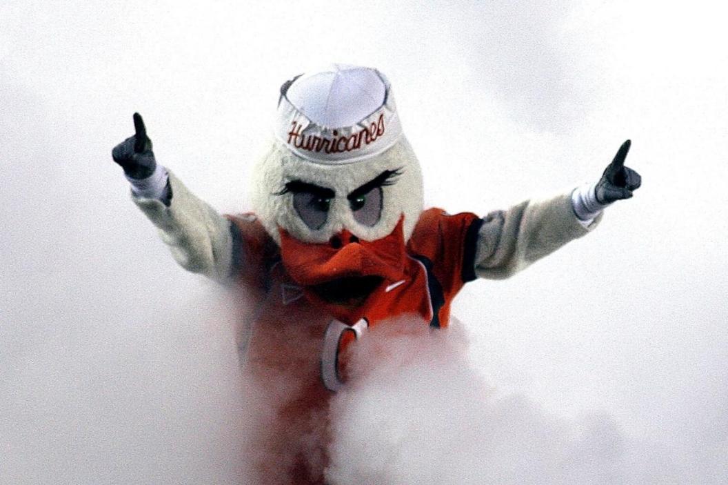 'Ibis' the University of Miami Hurricanes mascot runs through a smoke cloud prior to a game against the Florida International University Panthers at the Orange Bowl