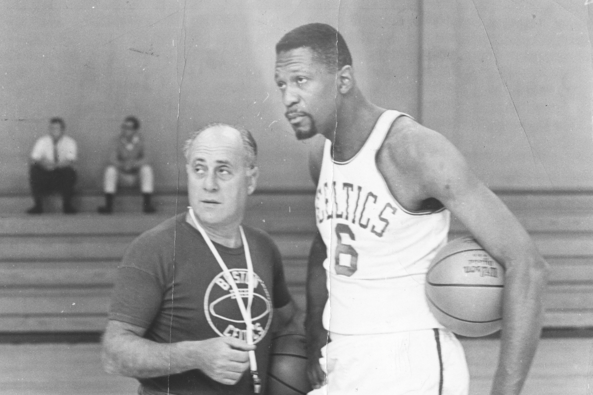 Boston Celtics coach Red Auerbach, left, talks to player Bill Russell during practice at Babson College
