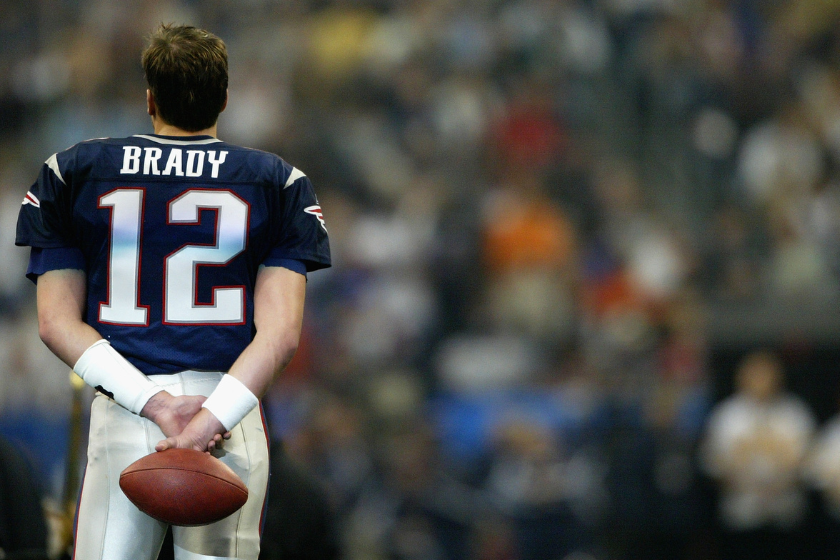 Quarterback Tom Brady #12 of the New England Patriots looks on before Super Bowl XXXVIII against the Carolina Panthers at Reliant Stadium