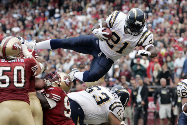 LaDainian Tomlinson jumps over a pile of players in a 2006 game.