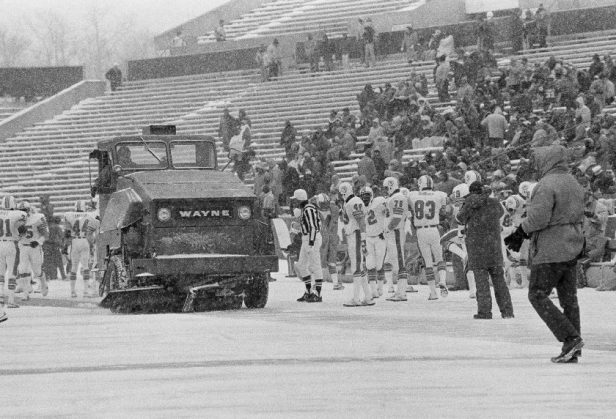 A street sweeper passes the Miami Dolphins bench on Sunday, Dec, 12, 1982 at Schaefer Stadium.