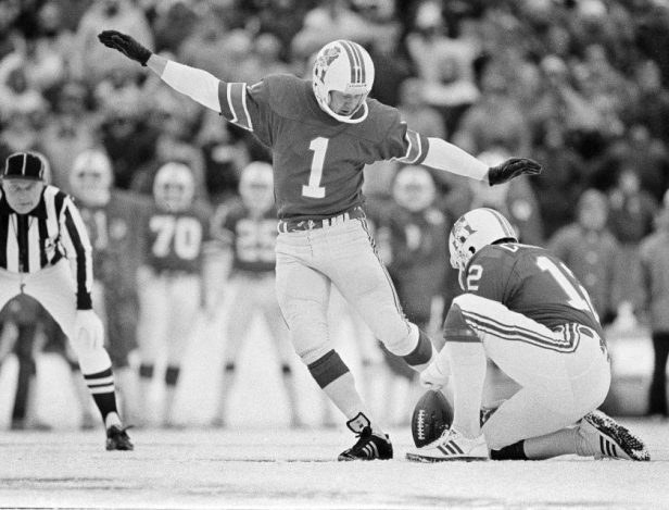 New England Patriots kicker John Smith prepares to kick the ball held by teammate Matt Cavanaugh in the fourth quarter with the Miami Dolphins at Schaefer Stadium in Foxboro, Mass., Dec. 12, 1982.