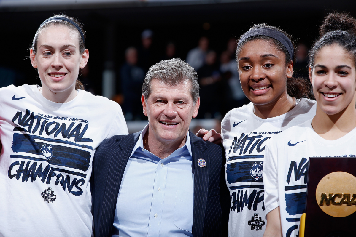 Geno Auriemma and players celebrate UConn's national championship.