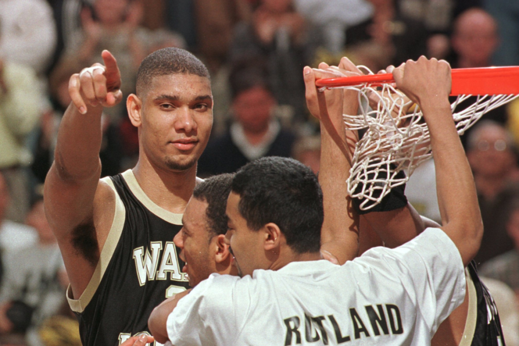 Tim Duncan #21 of Wake Forest, MVP of the game, points to the cheering crowd as they cut down the nets prior to the Deamon Deacons defeated Georgia Tech 75-74 to repeat as ACC Champions of the ACC Tournament at the Greensboro Coliseum