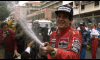 F1 driver Aryton Senna celebrates with fans.