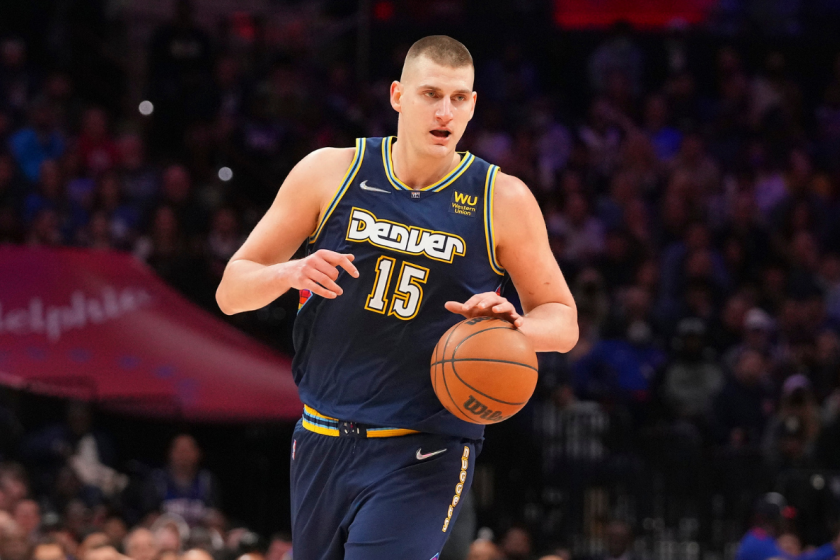 Nikola Jokic takes the ball up upcourt for the Nuggets