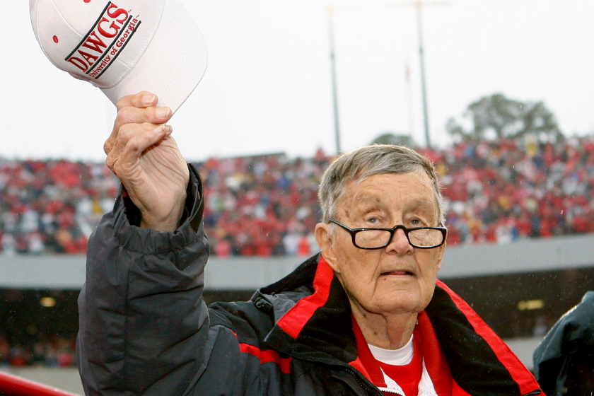 ormer long-time Georgia Bulldogs radio announcer Larry Munson acknowledges the crowd during a tribute to him after the first quarter of the game against the Georgia Tech Yellow Jackets