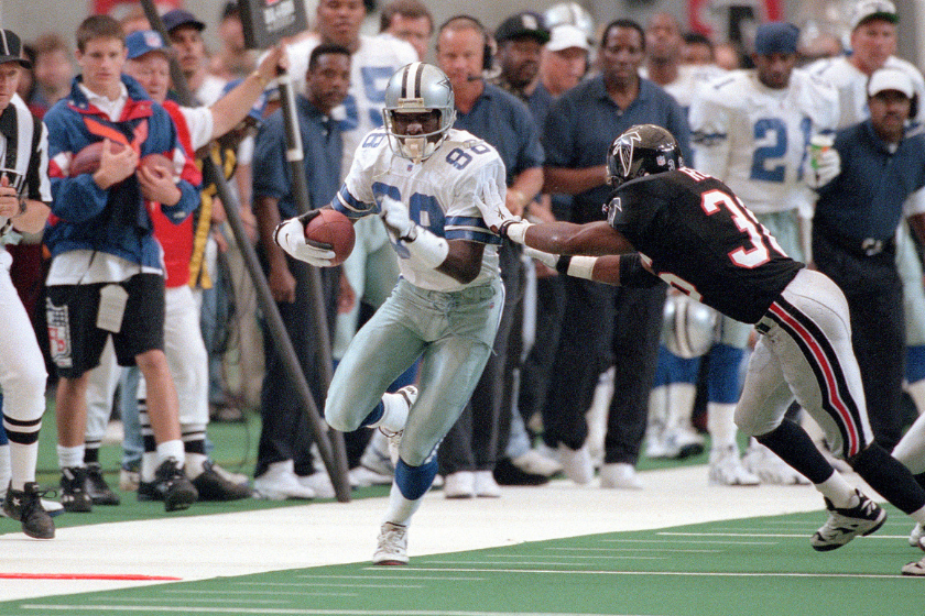 Michael Irvin catches a pass as the Dallas Cowboys face the Atlanta Falcons.