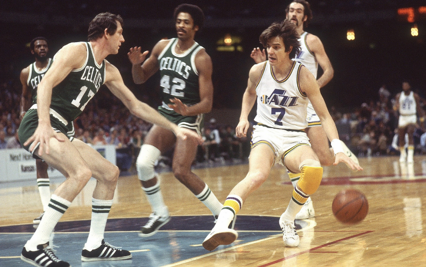 Pete Maravich of the New Orleans Jazz dribbles against the Boston Celtics.
