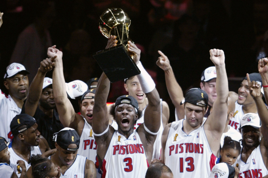 Ben Wallace of the Detroit Pistons hoists the Larry O'Brien Trophy after his team defeated the Los Angeles Lakers.