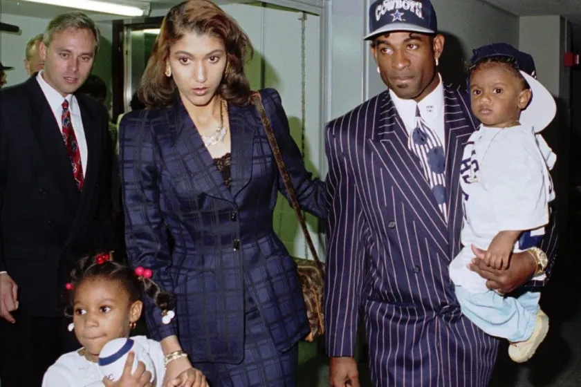 Deion Sanders walks with this first wife Carolyn Chambers.