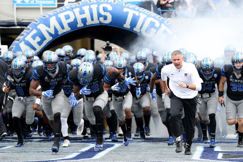 Mike Norvell, Head coach of the Memphis Tigers leads his team on the field before a game against the SMU Mustangs on November 18, 2017 at Liberty Bowl Memorial Stadium
