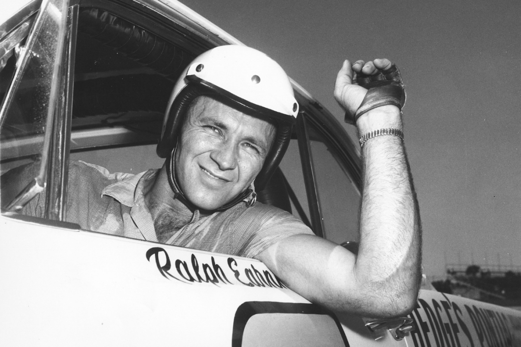 Ralph Earnhardt poses for a portrait while sitting in the driver seat circa 1950s