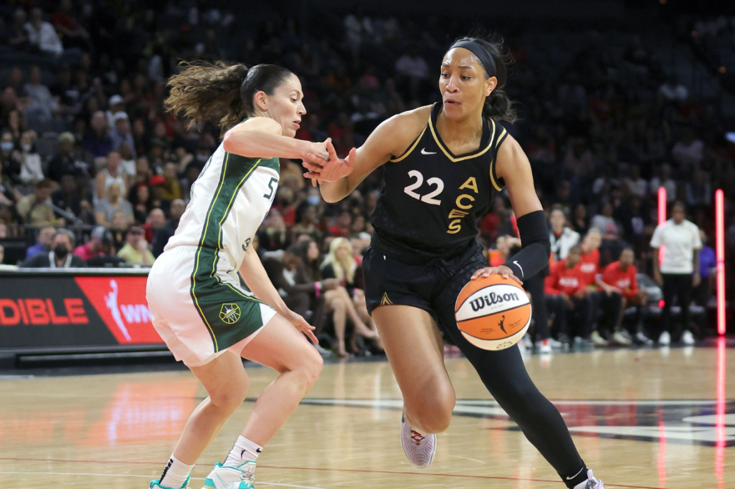 A'ja Wilson drives against Sue bird in a WNBA game
