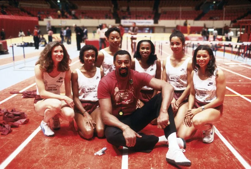 Former NBA star Wilt Chamberlain poses for this photo with young women for the Wilt's Athletic Club circa 1974/