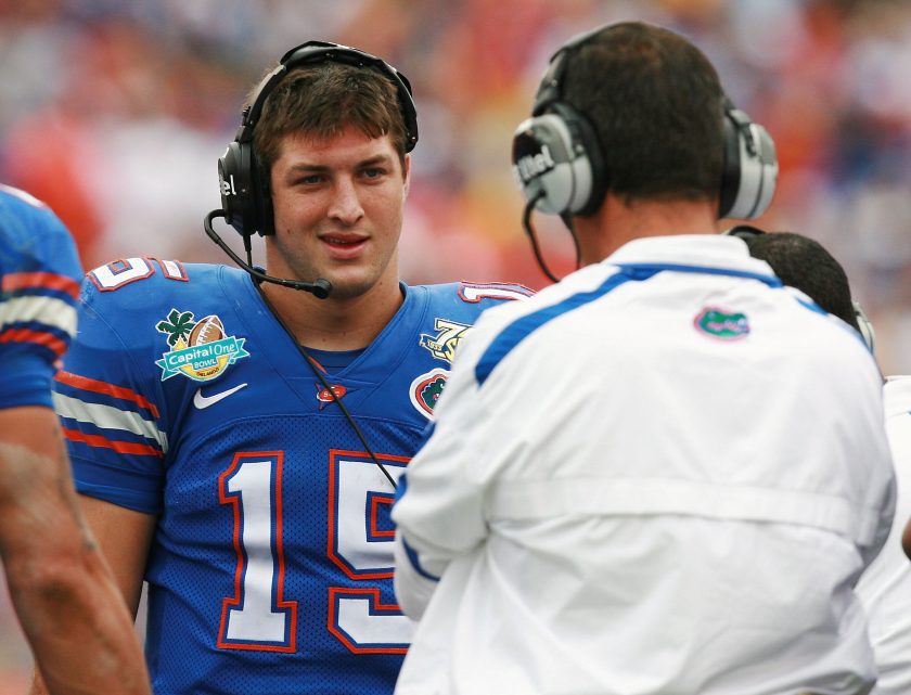Tim Tebow talks to Urban Meyer during a 2008 game.