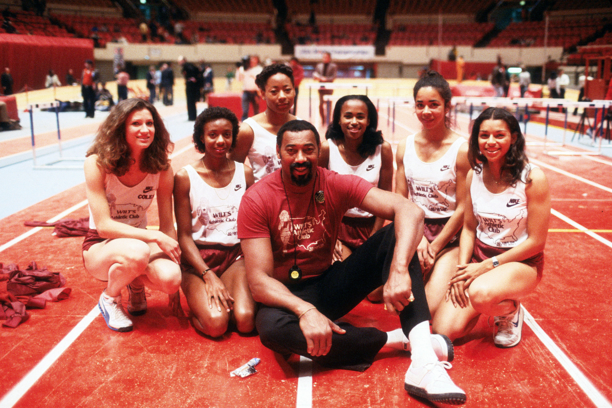 Former NBA star Wilt Chamberlain poses for this photo with young women for the Wilt's Athletic Club circa 1974