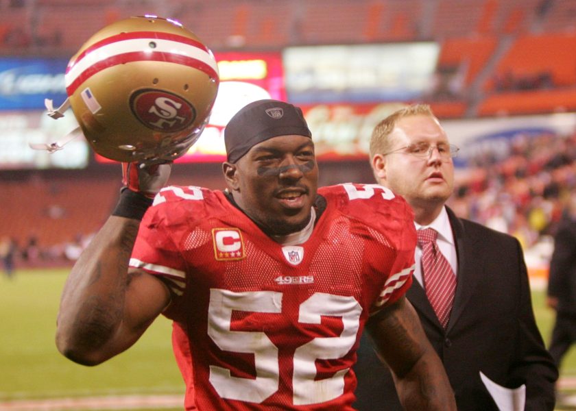 Patrick Willis raises his helmet after beating the Arizona Cardinals in 2009.
