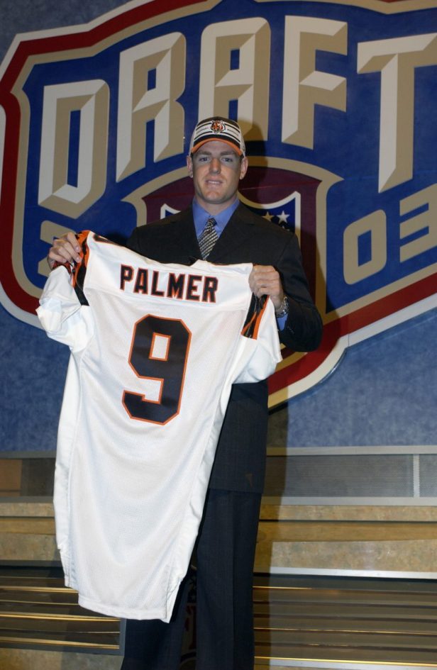 Carson Palmer holds up a jersey after being selected in the 2003 NFL Draft.