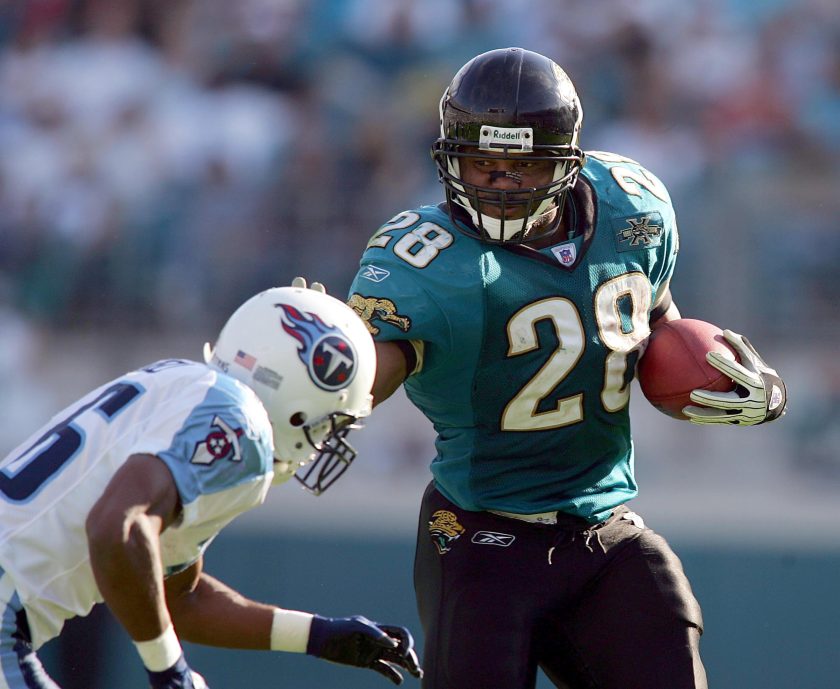 Jaguars running back Fred Taylor stiff arms an opponent in 2004.