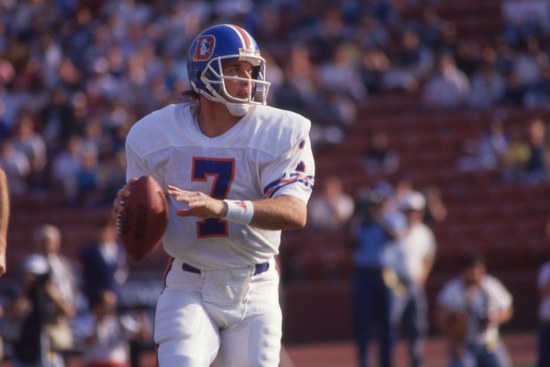 Denver Broncos quarterback John Elway rolls out to pass against the Los Angeles Raiders.