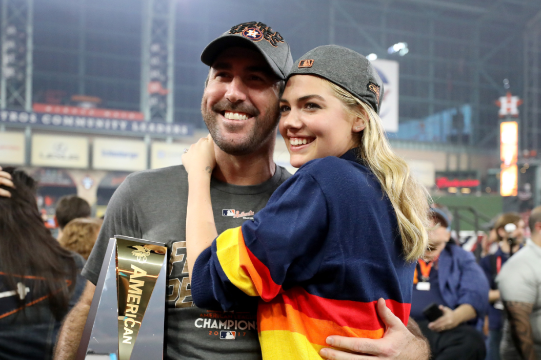 Justin Verlander #35 of the Houston Astros celebrates with model Kate Upton and the MVP trophy after defeating the New York Yankees by a score of 4-0 to win Game Seven of the American League Championship .