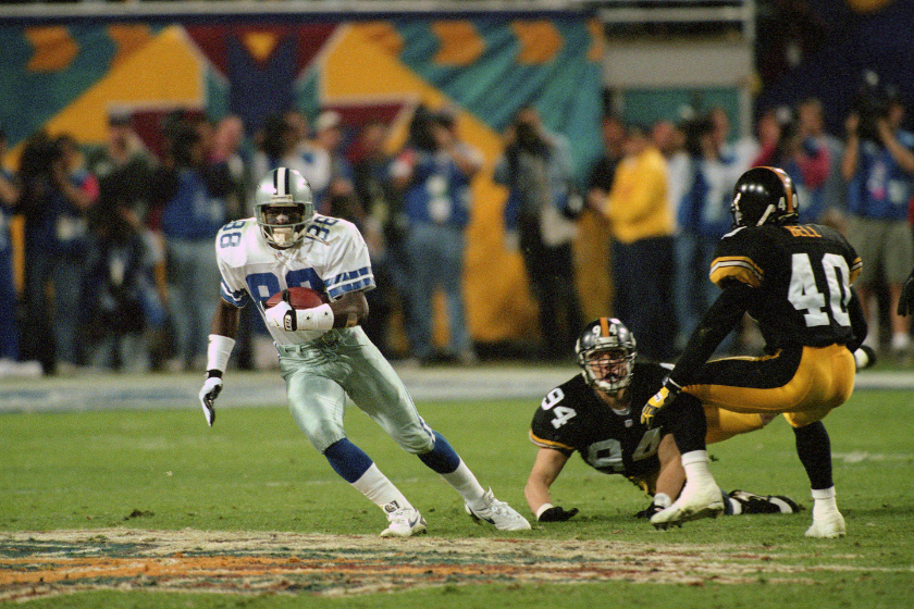 Dallas Cowboys wide receiver Michael Irvin looks for an opening after making a catch against the Pittsburgh Steelers in 1996.