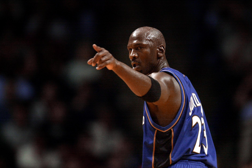 Michael Jordan points near the camera during a game