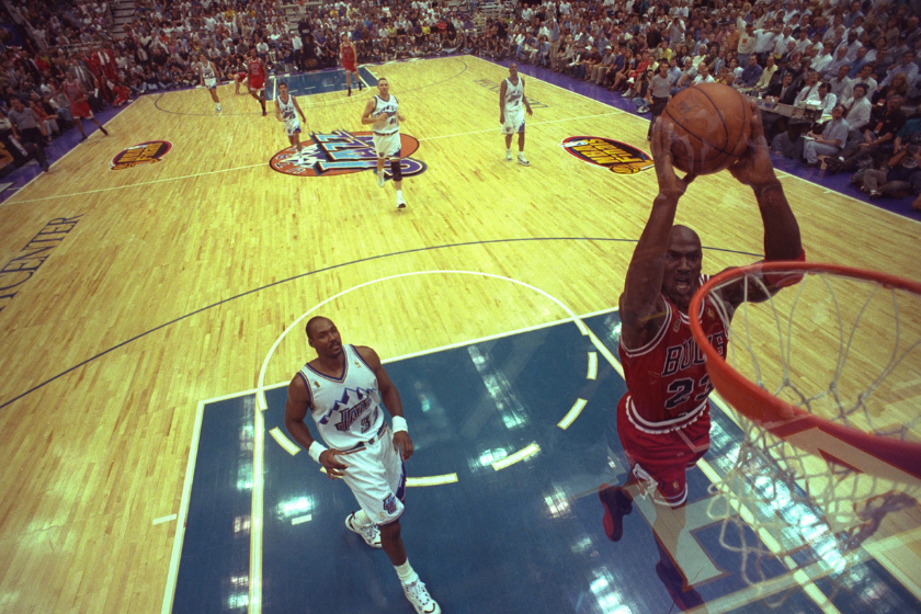 Michael Jordan soars for the dunk as Utah Jazz Karl Malone watches