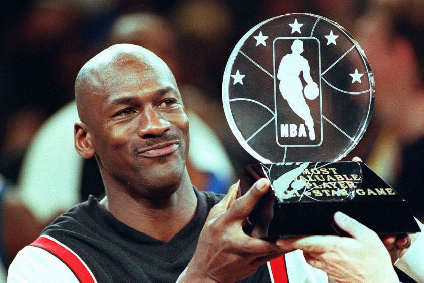Michael Jordan holds up the Most Valuable Player trophy