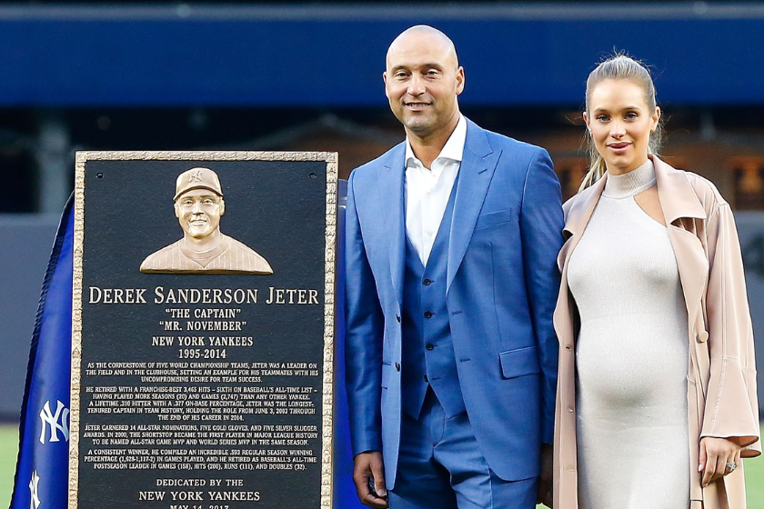 Derek Jeter poses with his Monument Park plaque with wife Hannah during his number retirement ceremony at Yankee Stadium