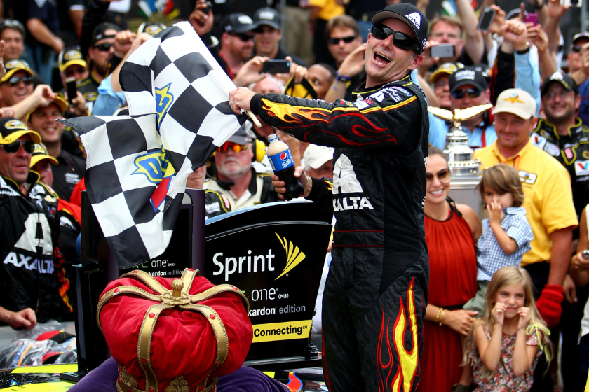 Jeff Gordon celebrates his fifth Brickyard 400 win by waving checkered flag