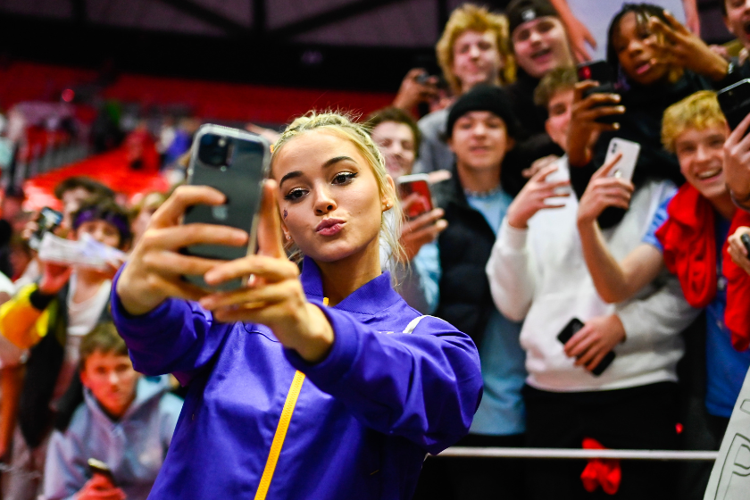 Olivia Dunne of LSU takes a 'selfie' with fans after a PAC-12 meet against Utah at Jon M. Huntsman Center