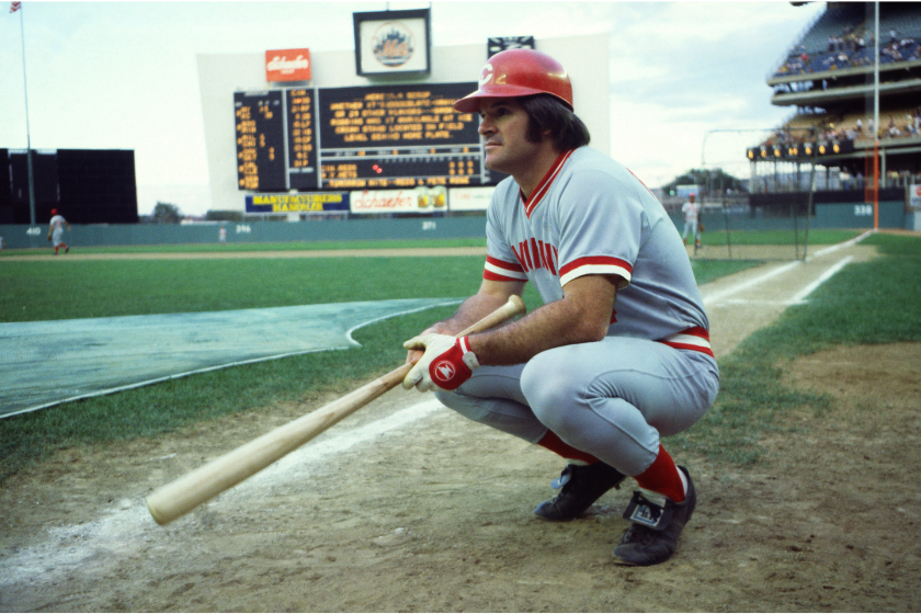 Pete Rose crouches before taking batting practice.