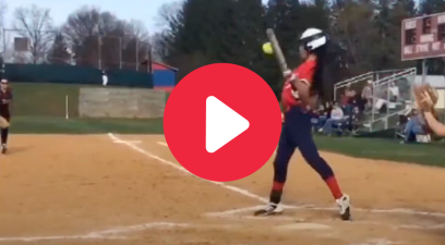 A softball player executes a behind-the-back bunt.