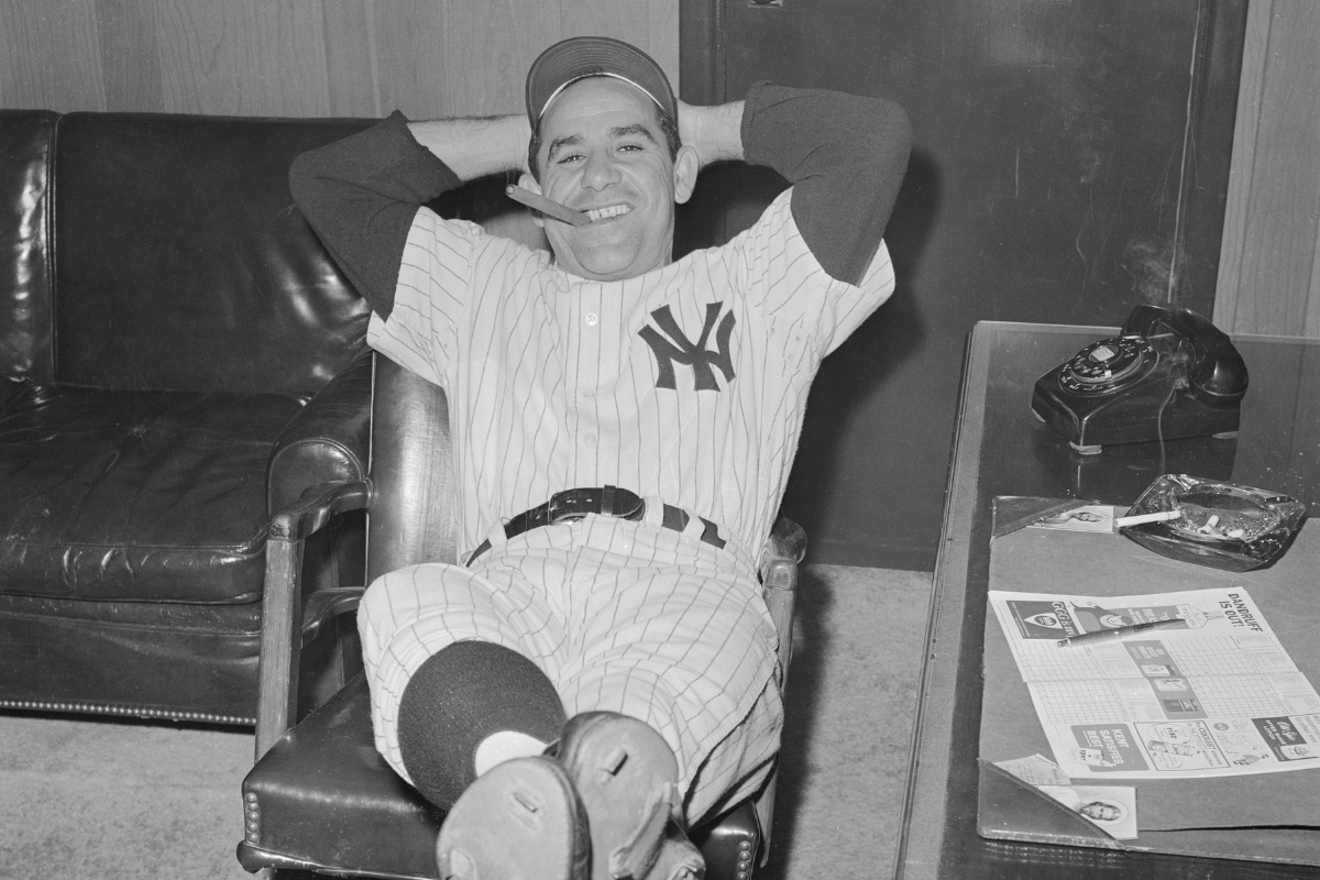 Yogi Berra smoking a cigar in celebration of the Yankees winning the American League pennant.
