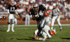 Bo Jackson rushes with the ball during an Oakland Raiders game.