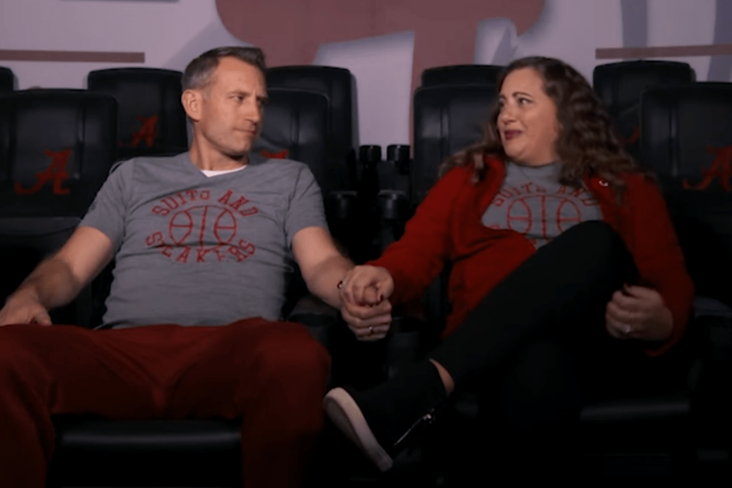 Alabama coach Nate Oats and his wife Crystal hold hands and embrace each other.