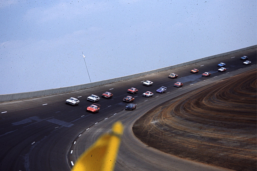 cars race around the track during the 1969 talladega 500