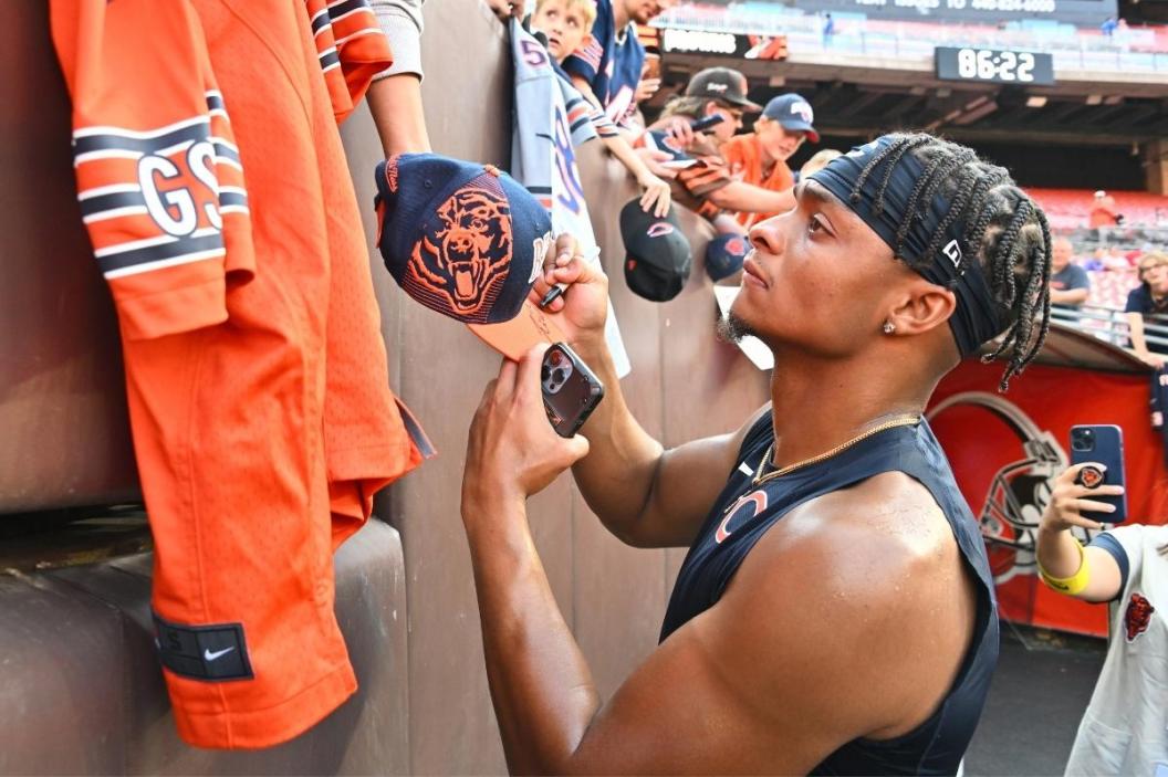 Quarterback Justin Fields #1 of the Chicago Bears signs autographs prior to a preseason game against the Cleveland Browns