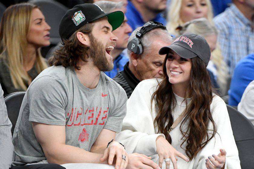 Bryce and Kayla Harper sit courtside at a game between the Ohio State Buckeyes and the Kentucky Wildcats