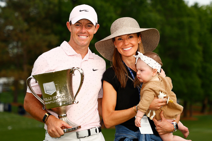 Erica Stoll and Rory McIlroy pose with the FedEx Cup
