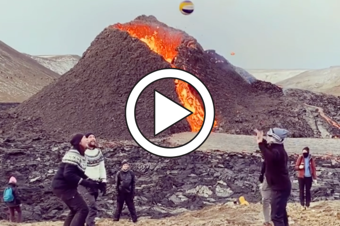 Daredevils Play Volleyball While Volcano Erupts Behind Them