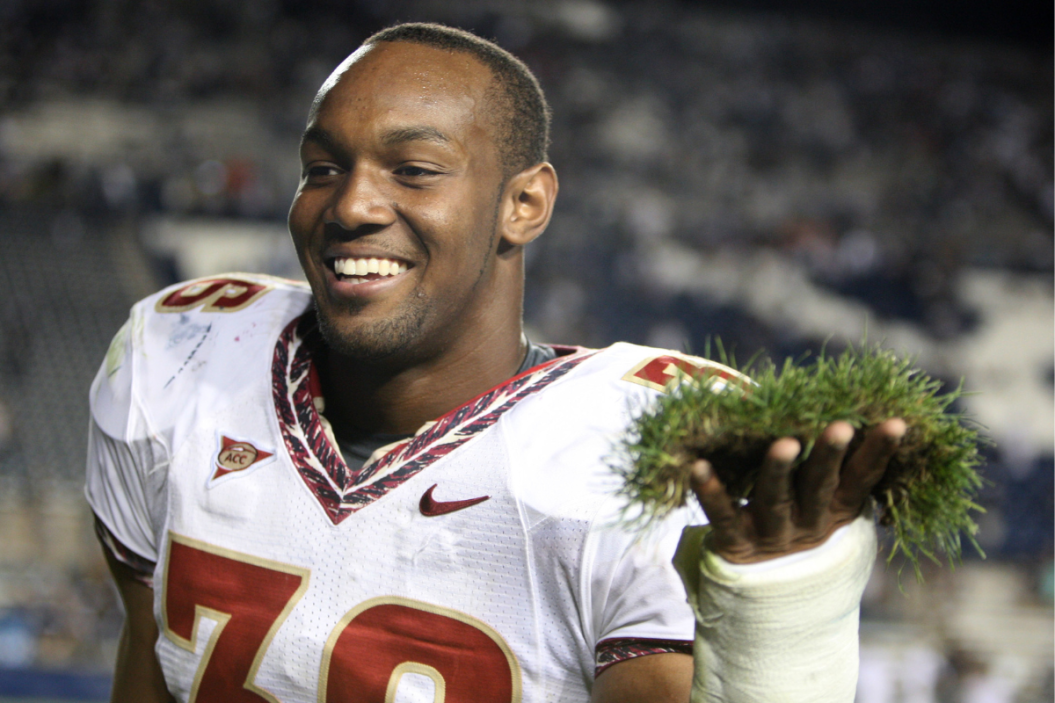 Dekoda Watson #36 of the Florida State Seminoles holds a piece of sod from the field to add to the sod cemetery after a win over the Brigham Young Cougars